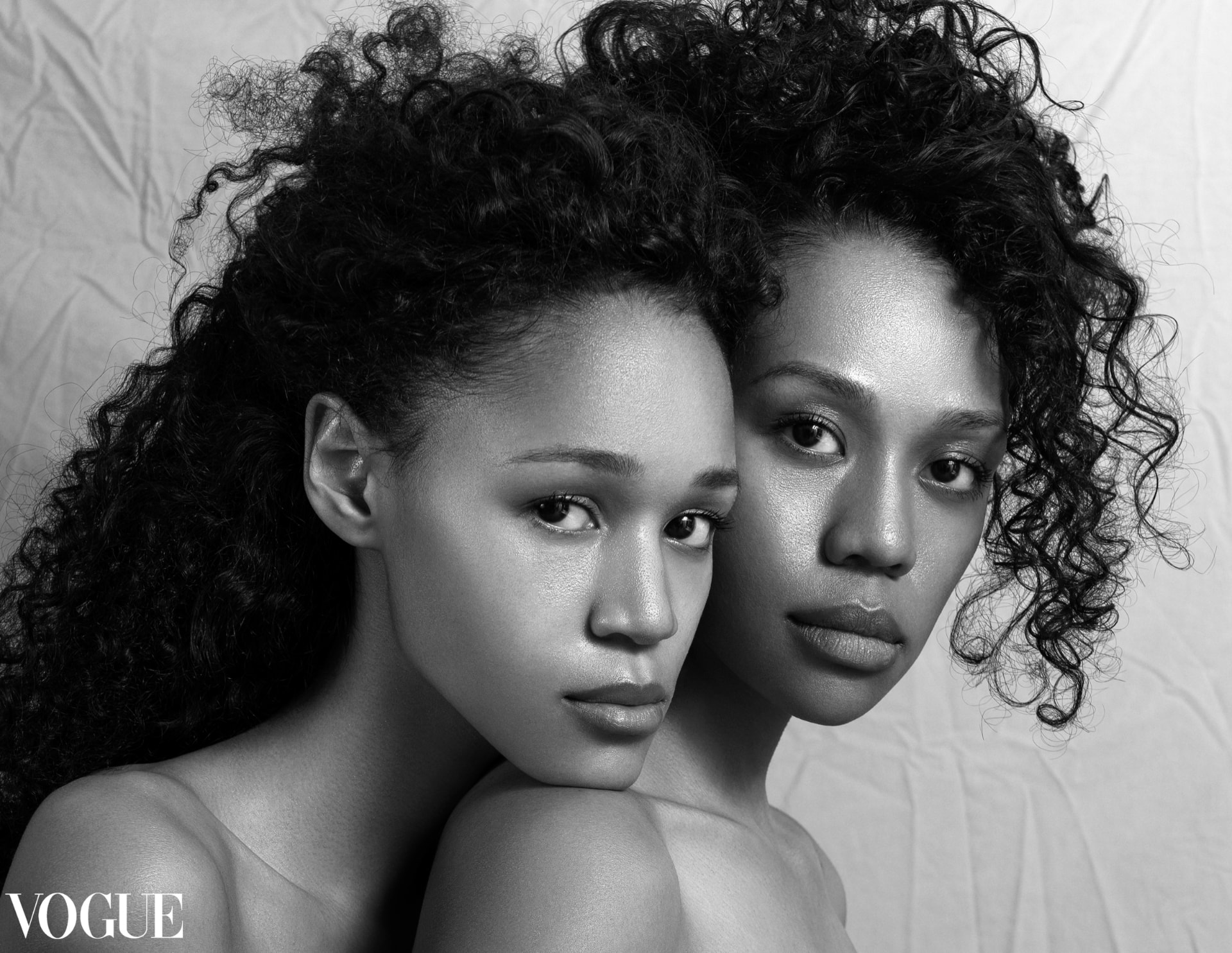 Black-and-white VOGUE editorial portrait of two women, featuring Lucinda’s retouching work